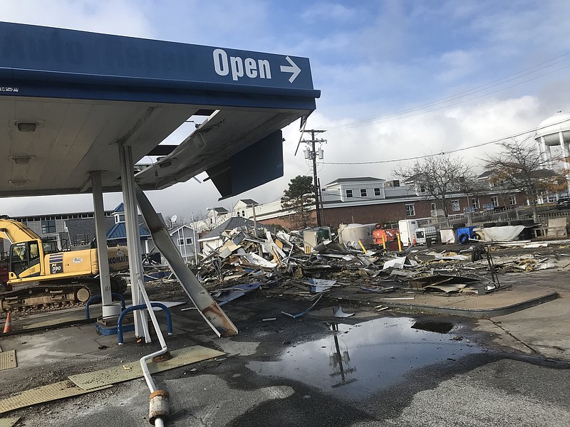 The old canopy that sheltered the gas pumps is surrounded by demolition rubble awaiting removal.