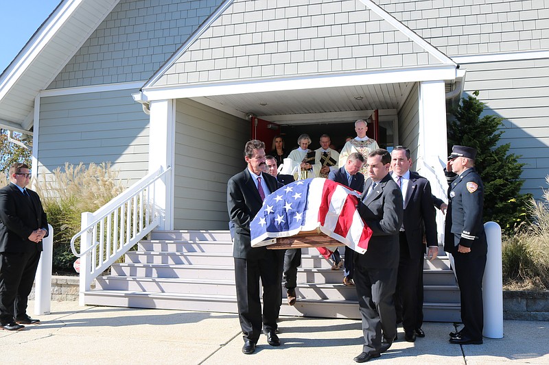 Pallbearers carry the flag-draped casket for William J. Hughes out of Holy Trinity Episcopal Church in Ocean City.