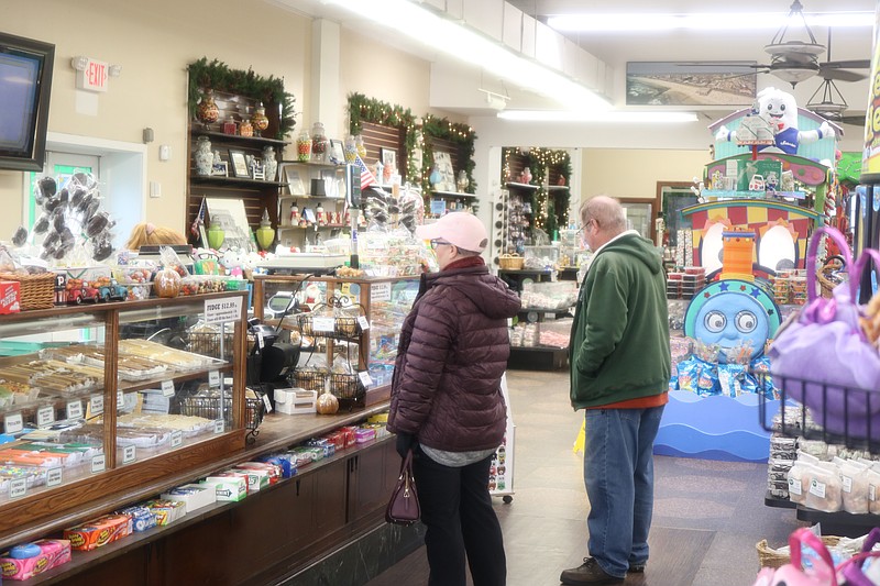 People duck into Shriver's Salt Water Taffy for some confections.