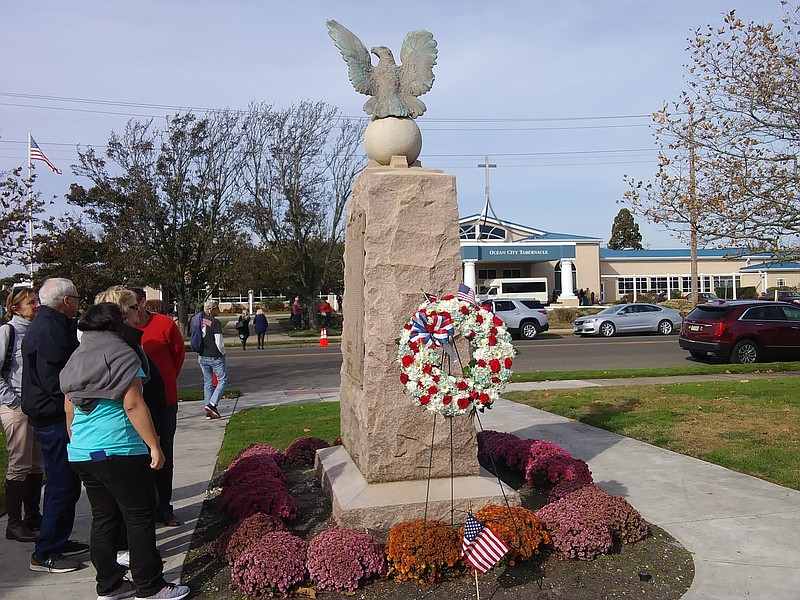 People gather to view the wreath at Veterans Memorial Park.