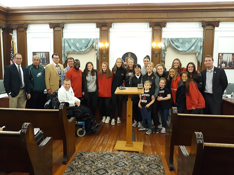 City officials and members of the Ocean City High School girls soccer team celebrate the state championship.