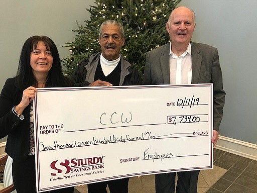 Bernie Blanks Sr., president of the Concerned Citizens of Whitesboro, accepts the donation from Sturdy Savings Executive Vice President Trina McSorley and Sturdy Savings Bank President and CEO Gerald L. Reeves. (Photo courtesy of Sturdy Savings Bank)