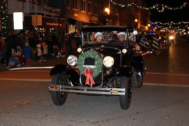 A 1930 car chugs along. 