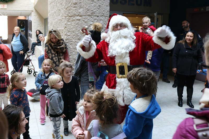 Santa brings jolly good cheers at the Holiday Festival in the Community Center.