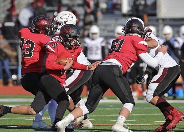 Junior quarterback Joe Repetti, who set a school record with 20 touchdown passes for the season, runs the ball with blocking support from CJ Conti (51). (Photos courtesy of OCHSfootball.com)