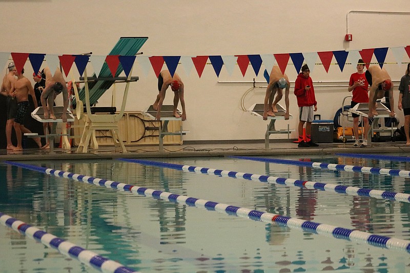 Swimmers ready themselves for the start of the 100 yard freestyle.