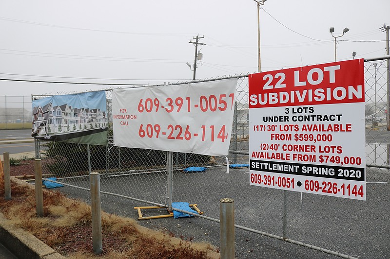 A sign and an architectural rendering give a sneak preview of the proposed housing project.