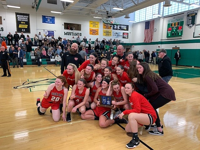 The Ocean City girls basketball Red Raiders celebrate their South Jersey Group 3 championship on March 10.