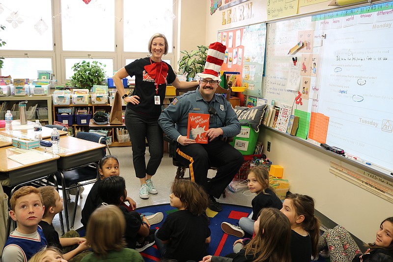 Ocean City Officer Jack Davis does his best Dr. Seuss "Cat in the Hat" impersonation while reading to children at the Primary School Monday. 