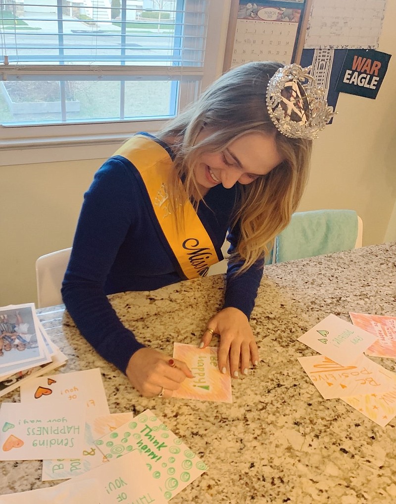 Miss Ocean City Mary Grace Jamison smiles as she crafts her letters.