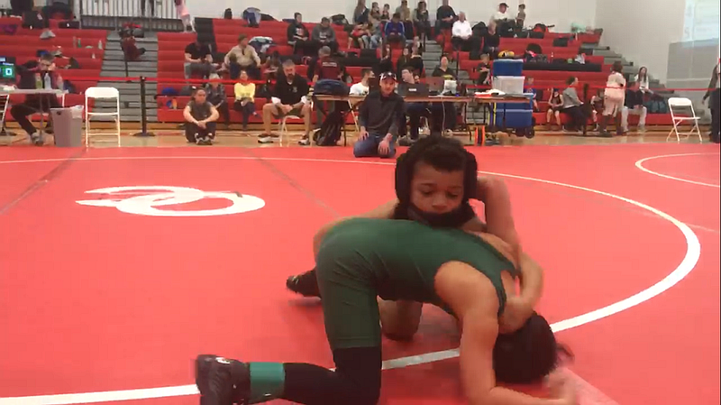 Darrien Mayo, facing camera, grapples with an opponent during the tournament in Ocean City.