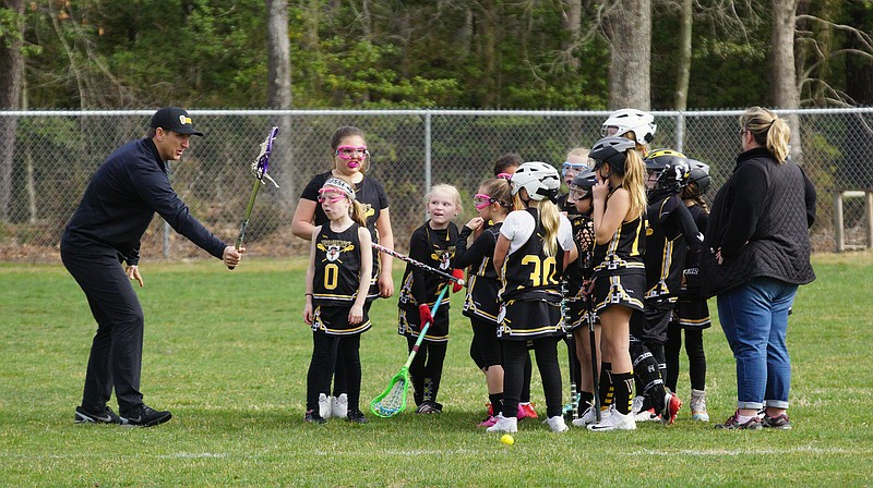 During a workout before the pandemic, Ray Clark, left, coaches the Warriors youth lacrosse team. (Photo courtesy of Ray Clark)