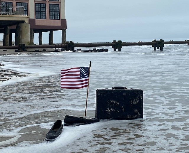 John Walton’s Business Person’s Plunge display is soaked as the tide begins to come in, providing symbolism of an event that has become a tradition.