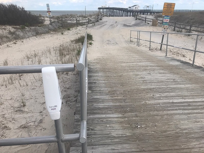 Hand sanitizer dispensers, left, like this one are installed at locations on the Boardwalk and downtown.