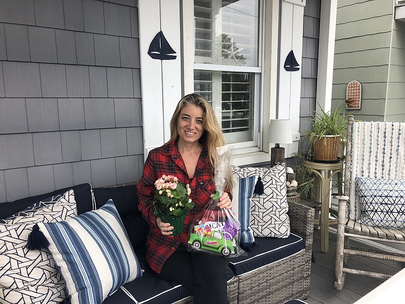 Ocean City resident Jen DeVlieger, a kindergarten teacher, receives a gift bag and potted plant from the PTA.