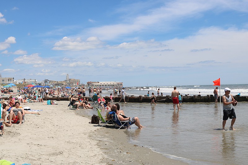 People use social distancing while enjoying the beach May 30.