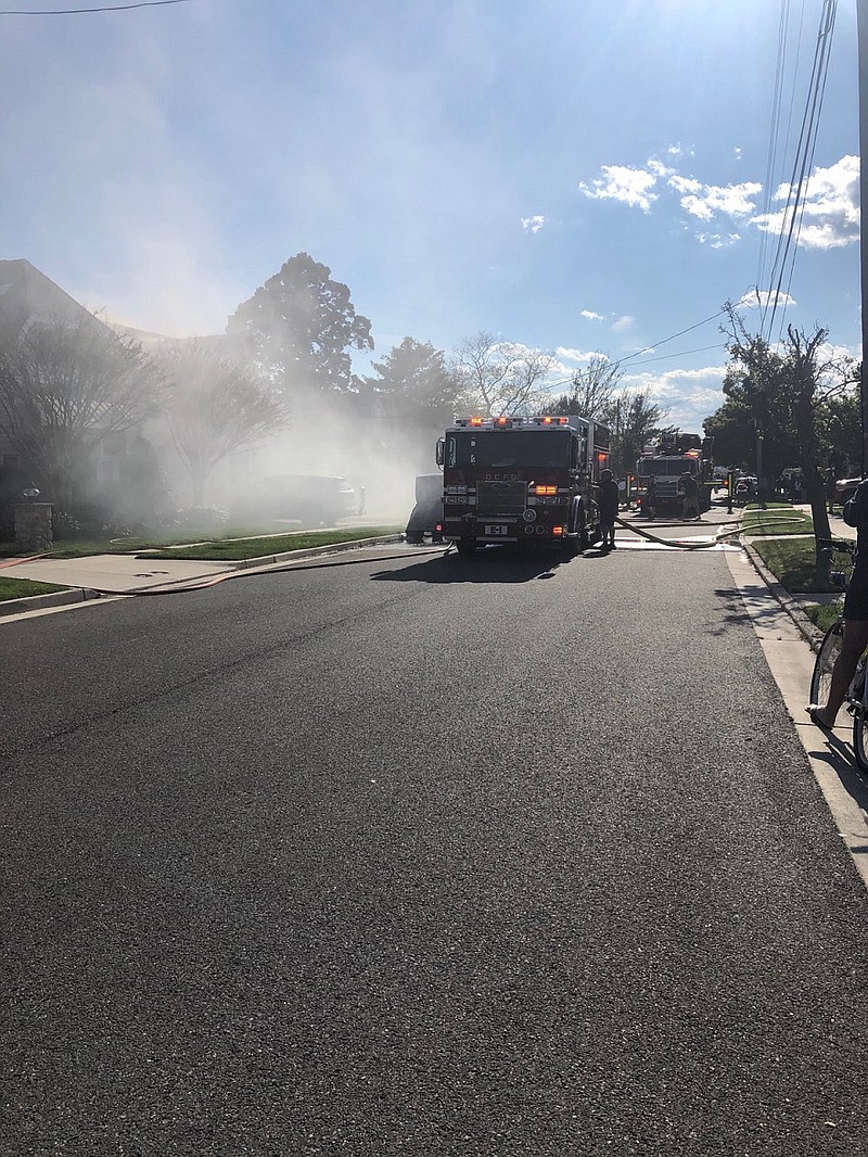 Smoke billows from the house as Ocean City firefighters extinguish the blaze.