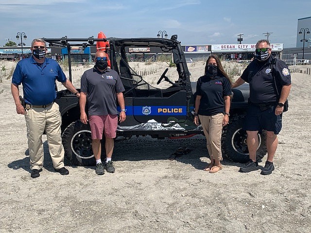 From left, Police Capt. Charlie Simonson with Len and Danielle Polistina of Municipal Equipment Enterprises, who offered the vehicle for a trial period, and Officer Mike Gray.
(Photo courtesy Ocean City Police Department)