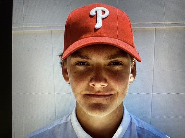 Jake McKenna tried on the cap of his new baseball organization.  (Photo courtesy of McKenna family)