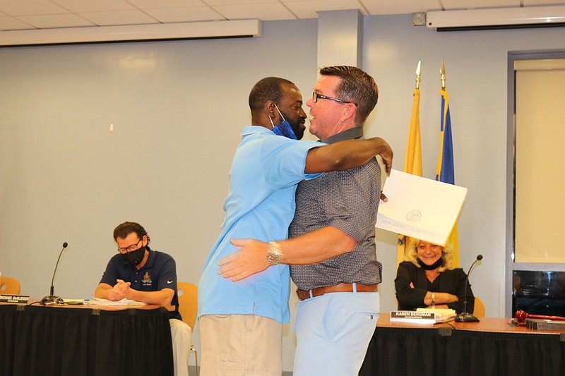 Councilman Tony Wilson, right, exchanges a hug with state Assemblyman Antwan McClellan.