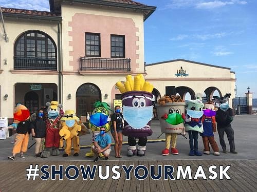 Show Us Your Mask mascots wear their face coverings as part of a public campaign to help prevent the spread of COVID-19.