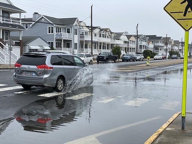 Later in the afternoon floodwaters begin to recede making it somewhat passable for cars.