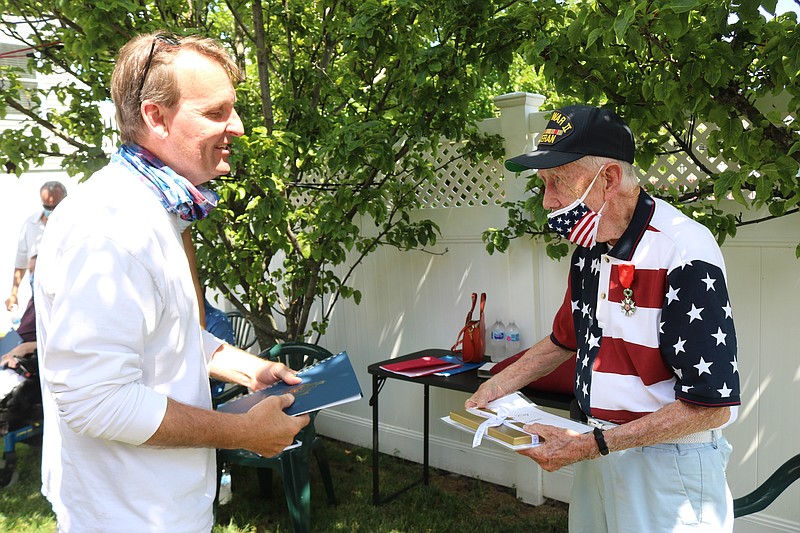 Mayor Jay Gillian hands veteran Francis X. McCormac the key to the city.