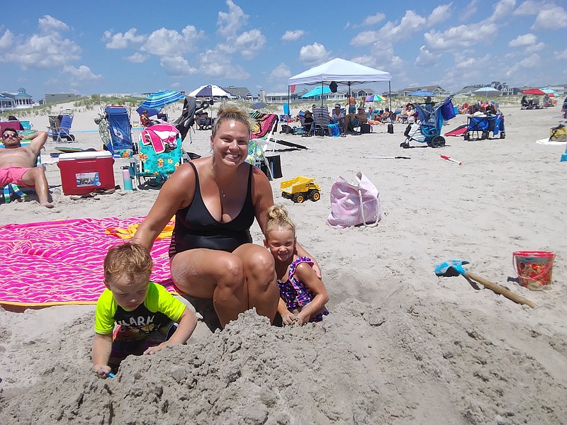 Alicia Crist, of Delaware County, Pa., helps her children, Taylor, 4, and 2-year-old son, Robbie, make sandcastles at 34th Street beach. 