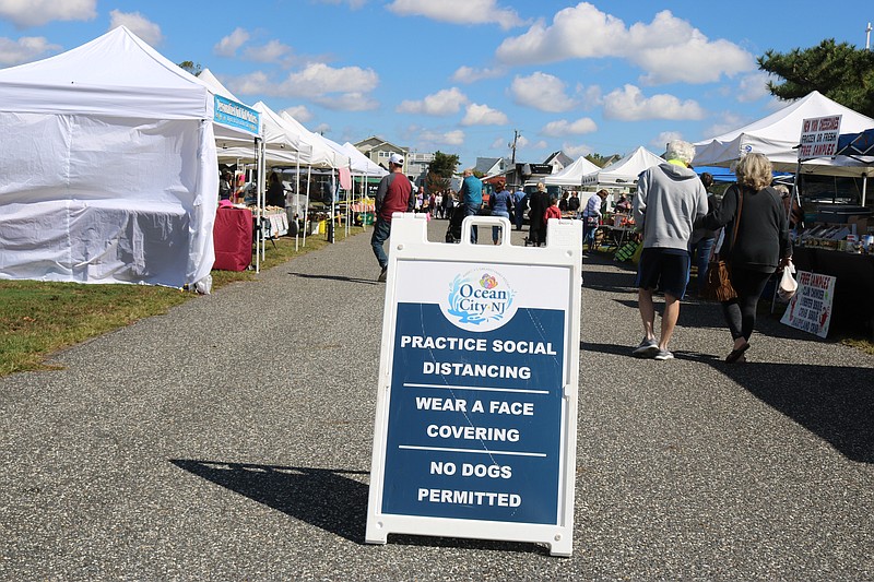 A sign serves as a reminder for shoppers to wear a face covering and practice social distancing.