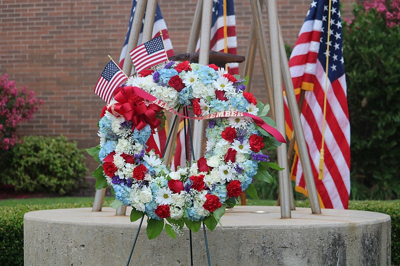 A memorial wreath bears the words, "Always Remember."