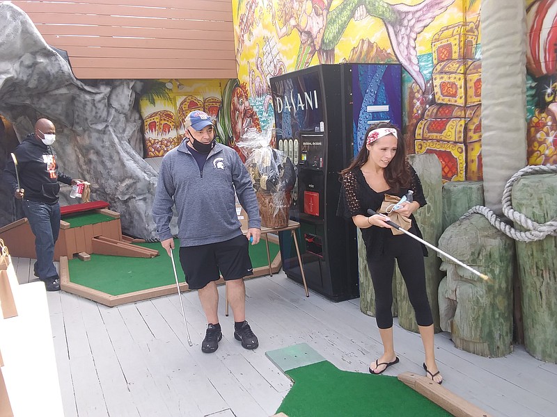 Nikki Axler, of Ventnor, who is in a sober living house, is happy to try her hand at miniature golf for a good cause.