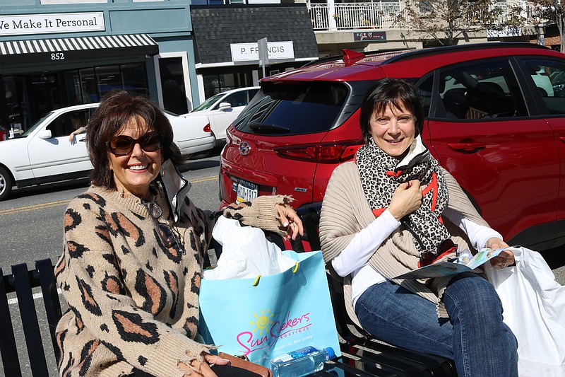 Sisters Lana Felfera, left, of South Chester County, Pa., and Gina Hookey, of Princeton, take a break in between shopping in the downtown.