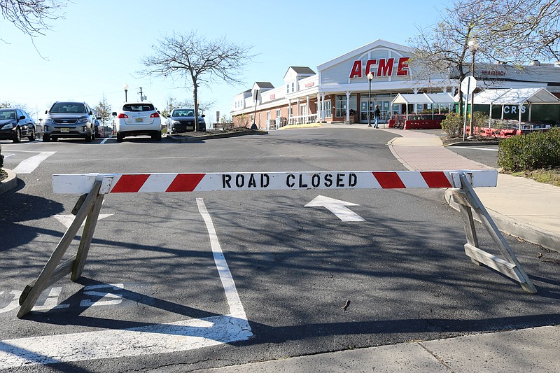 A wooden barrier blocks the driveway while the supermarket is temporarily closed following a fire.