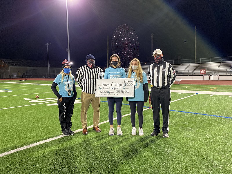 From left, presenting the fundraising check for Waves of Caring are Advisor Ashley Schmid, Assistant Principal/Referee Jerry Brown, Key Club President Vanessa Karayiannis, Vice President Grace Gleason and Athletic Director/Referee Geoff Haines.