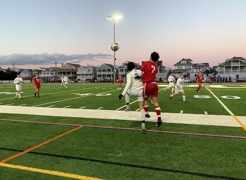 Chris Catona battles for a header in a fierce aggressive game.