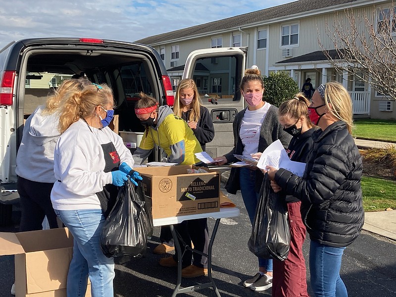 Volunteers, including members of the Ocean City High School Key Club, unload Thanksgiving meals for residents at Wesley by the Bay.