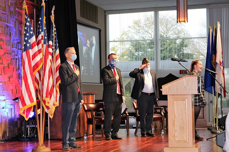 From left, Michael Allegretto, aide to the mayor, Mayor Jay Gillian, VFW Post Commander Mike Morrissey listed as Julia Mary Wilson sings. 