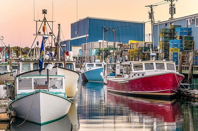 Fishing Boats moored to wooden Piers at Sunset. Photo  Credit:  RODA website