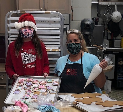 Kookie Kids volunteer Sydney Chin, 10, of Ocean City, helps Jen Bowman decorate some holiday cookies at St. Peter's United Methodist Church. Proceeds of sales will go to helping families in need. (Photos courtesy Jen Bowman)