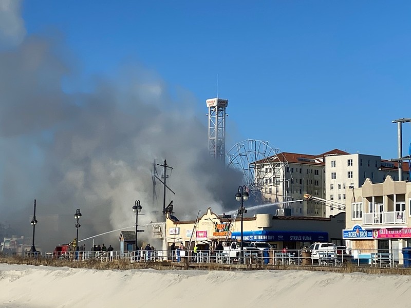 Smoke billows toward the ocean.