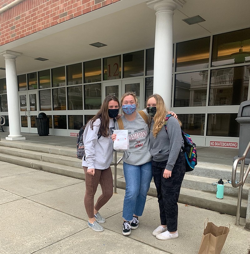 From left, Kookie Kids volunteer Andi Helpenstine with Katie and Kelsea Bowman.