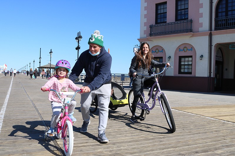 Chris and Angela Myers, of Ocean City, and their children, Gracelyn, 4, and baby, Christopher, try out their new bicycles.