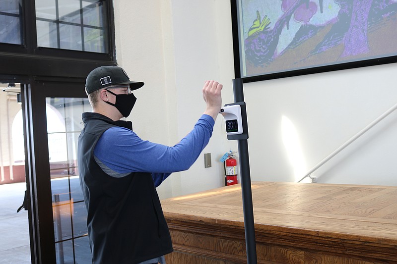 Justin Babel, of Sicklerville, has his temperature checked by an automated thermometer as he enters the Music Pier.