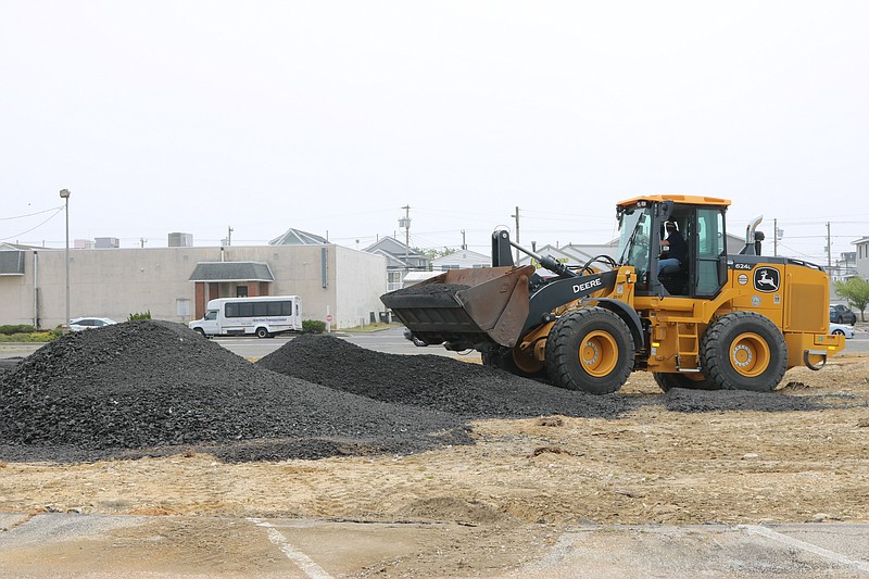 This week workers are creating a temporary parking lot and area safe to walk on at the former car dealership.