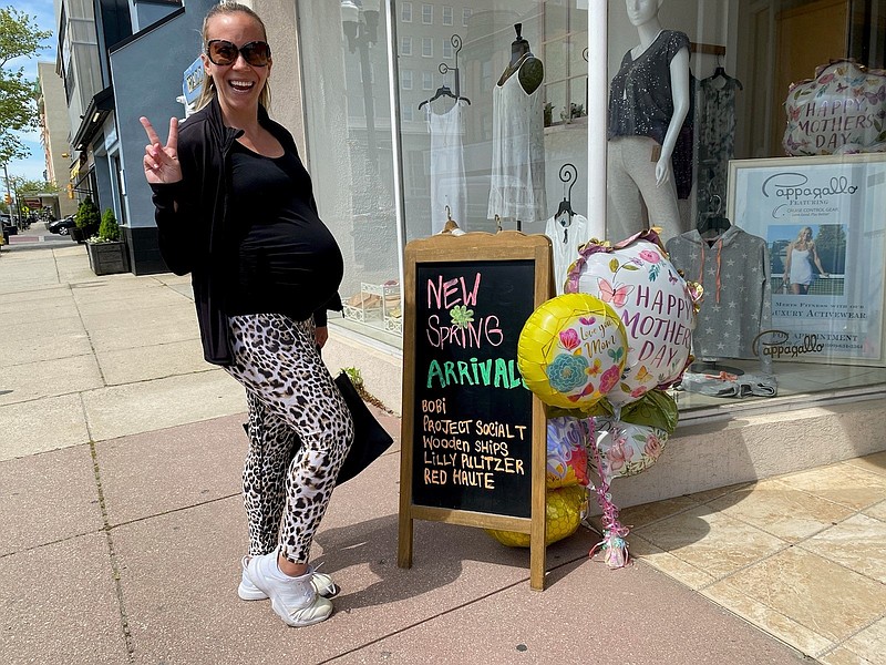 Katie Miccarelli shows off her “baby bump” while shopping for Mother’s Day on Asbury Avenue.