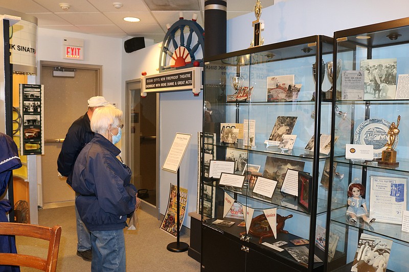 Patrons view some of the pieces from the theater exhibit.