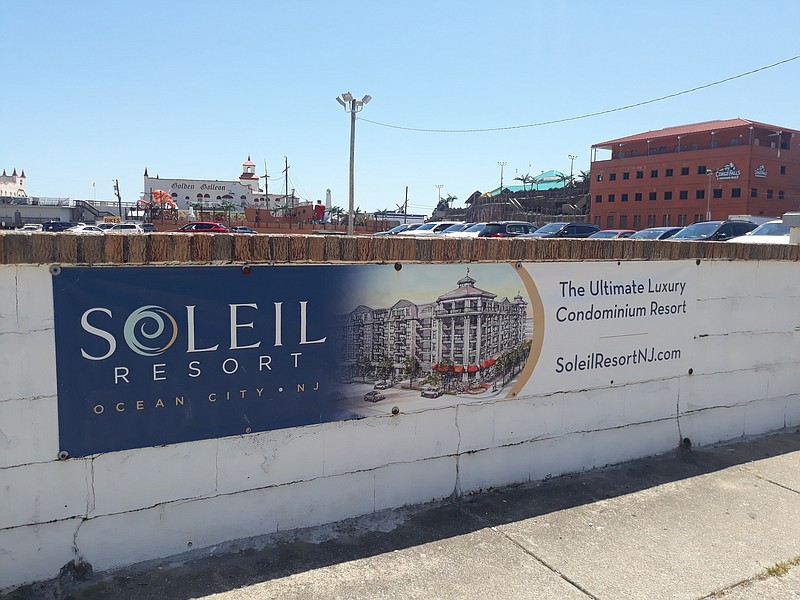 An architectural rendering on a sign at the Soleil Resort property depicts what the condo-hotel would look like when completed.