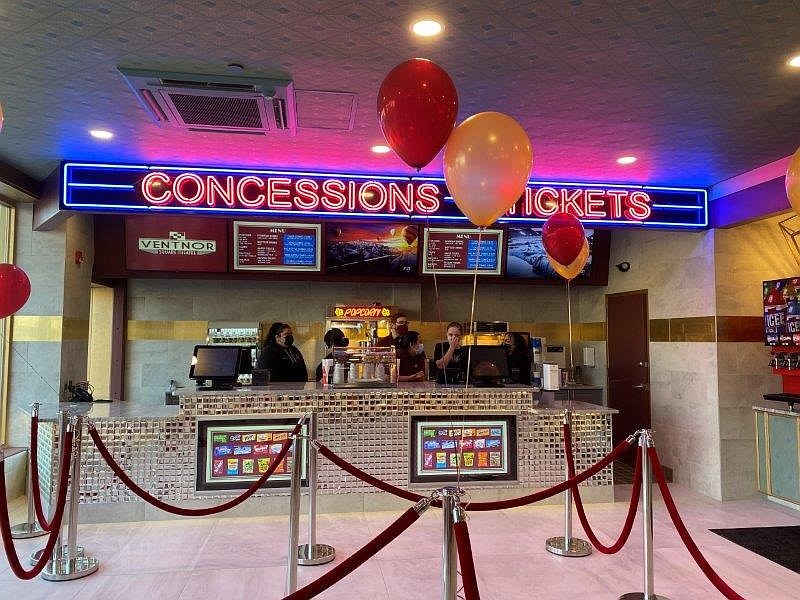 The theater features a brightly colored ticket lobby.