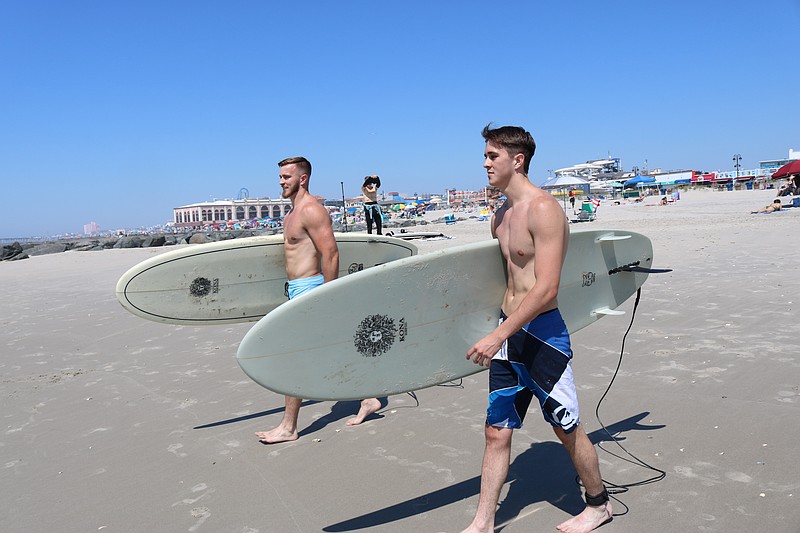 Brothers Sean and Patrick Burke, of Drexel Hill, Pa., check out the waves.