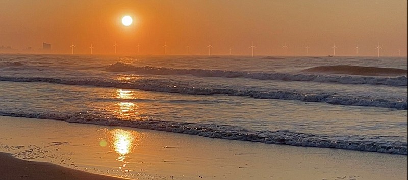 A rendering depicts what the wind farm's turbines might look like offshore in the distance during sunrise in Ocean City. (Courtesy of Joe Mamaa)